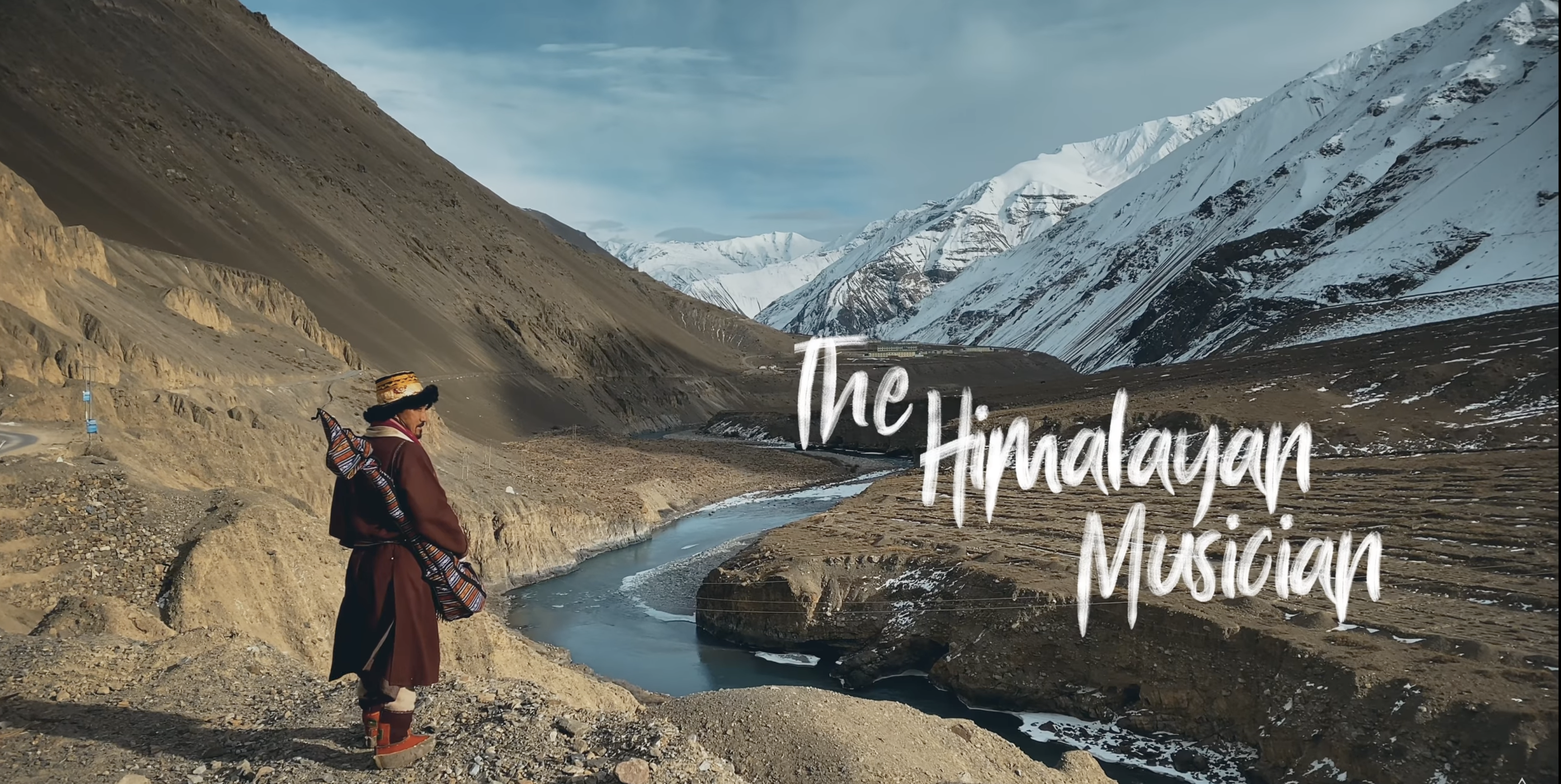 The Himalayan Musician: a musician overlooking a Himalayan river valley